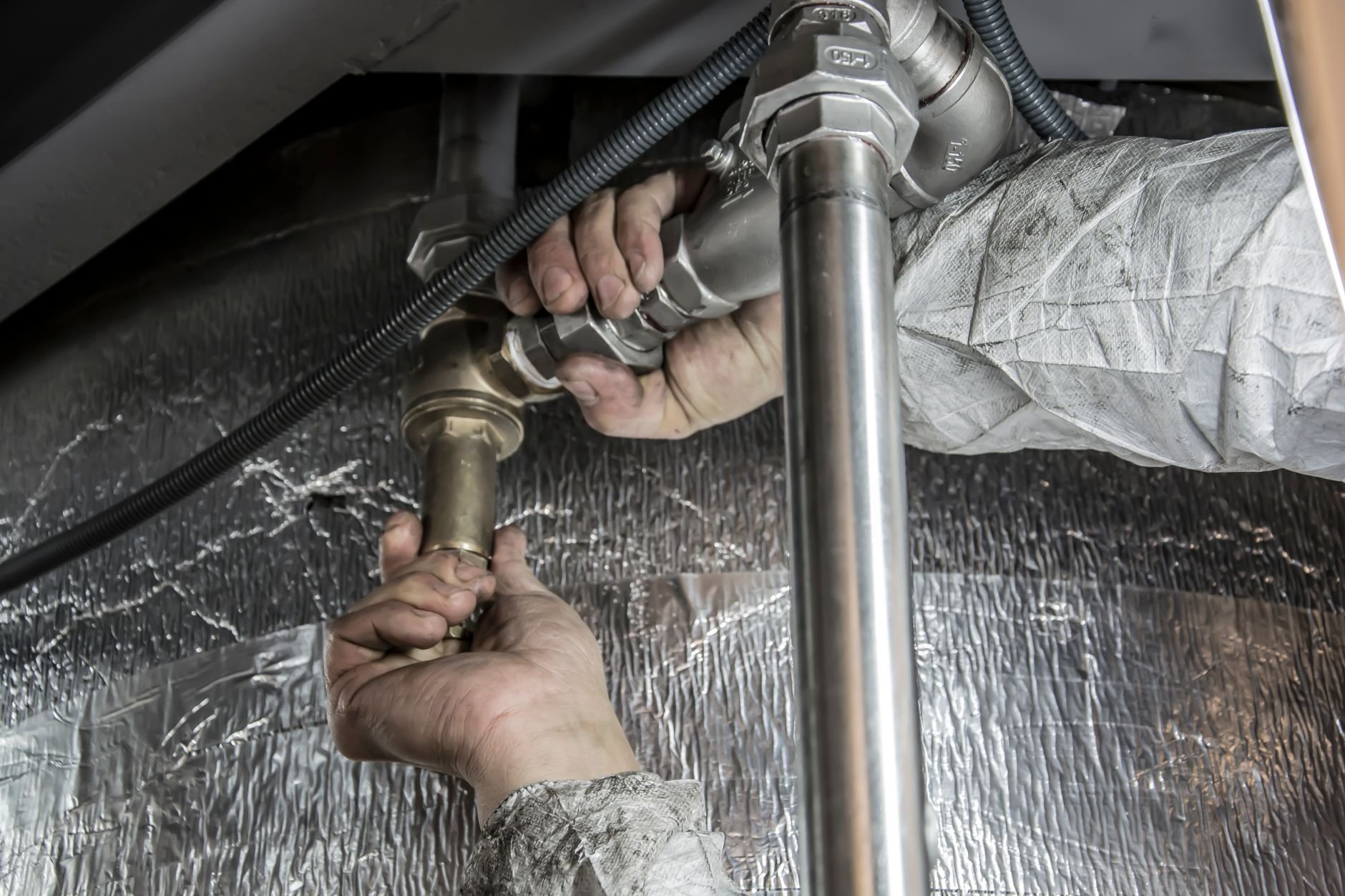 Close-up of a plumber installing pipes — the type of skilled local service professional Foundly helps get found on Google