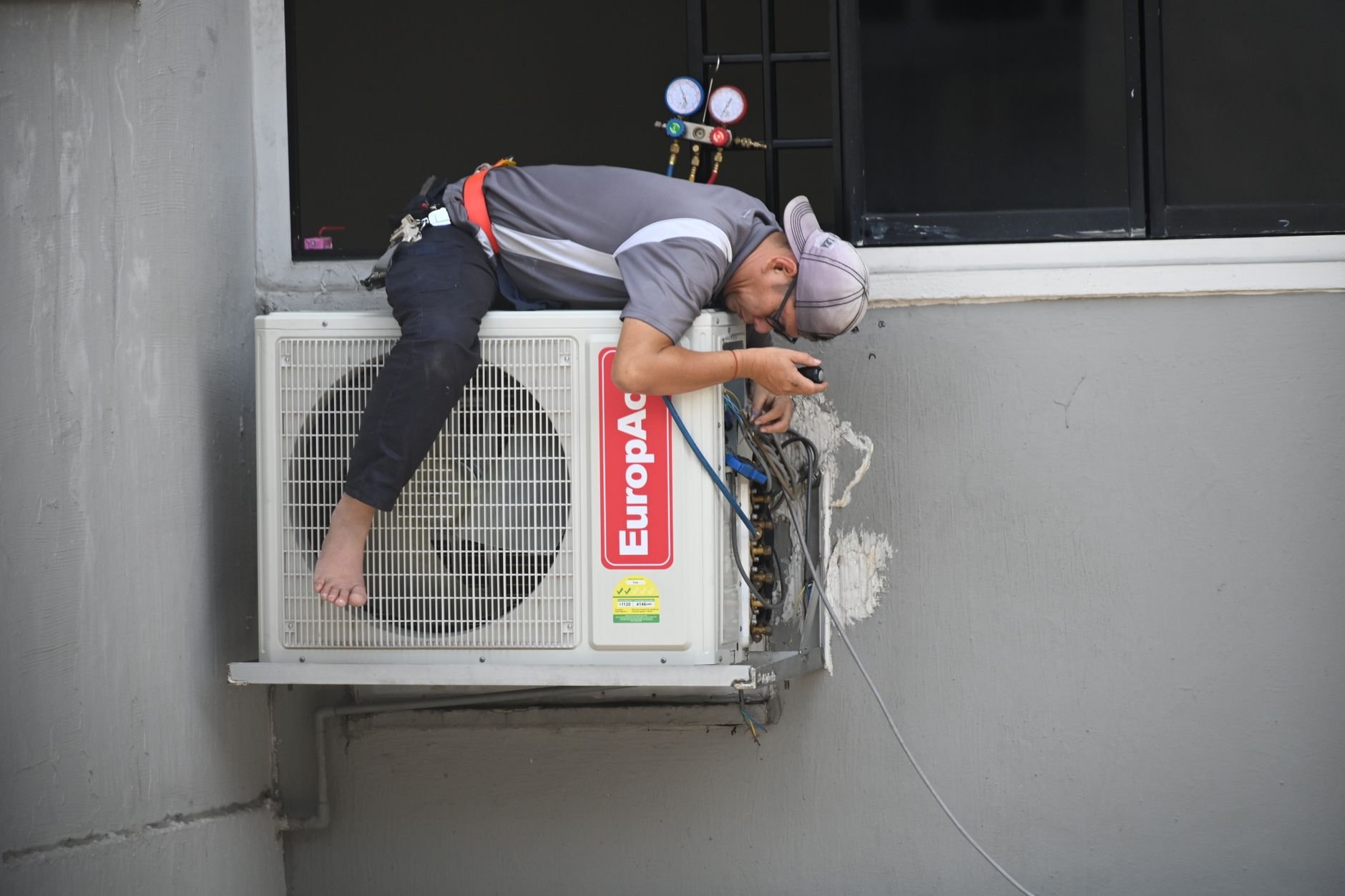 A technician repairing an outdoor air conditioning unit — the kind of local service business Foundly helps rank on Google
