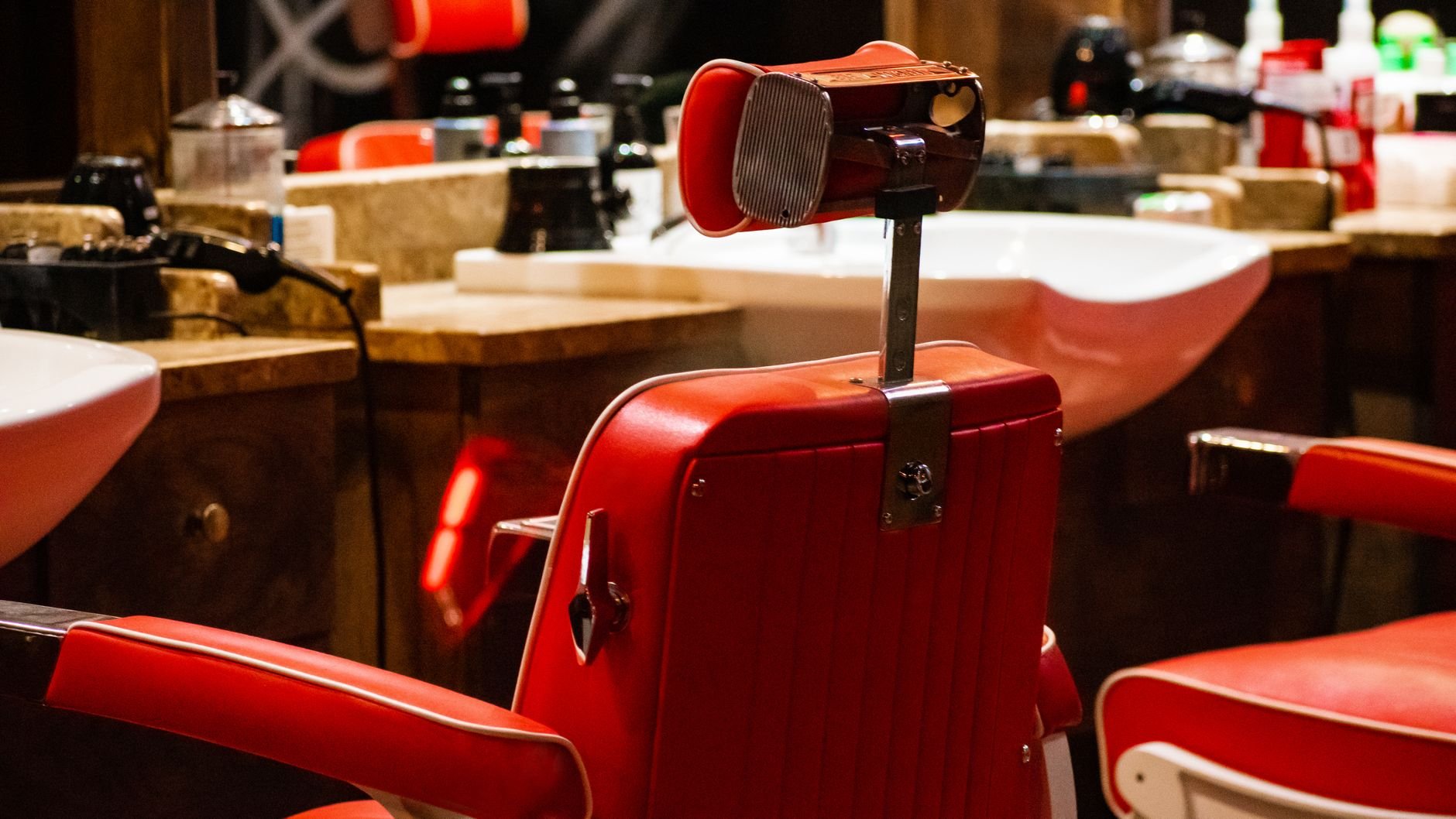 Vibrant red barber chair in an empty modern hair salon — one of the local service industries Foundly serves